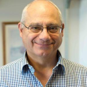 Dork Sahagian headshot smiling at the camera.